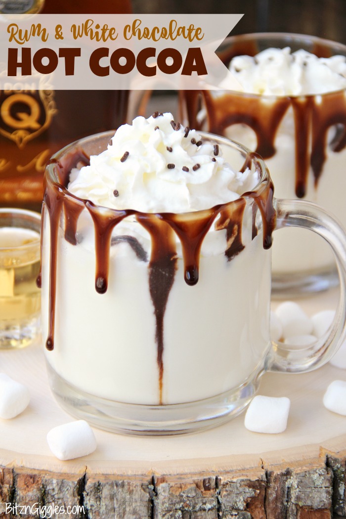 Rum & White Chocolate Hot Cocoa - a heavenly combination of white chocolate, rum, marshmallows, drizzles of chocolate and a big swirl of whipped cream topped with sprinkles is the ultimate fall indulgence!