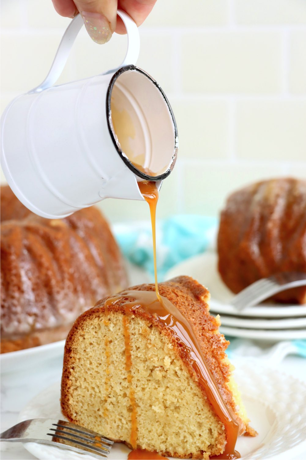 pouring caramel glaze over a piece of butter cake