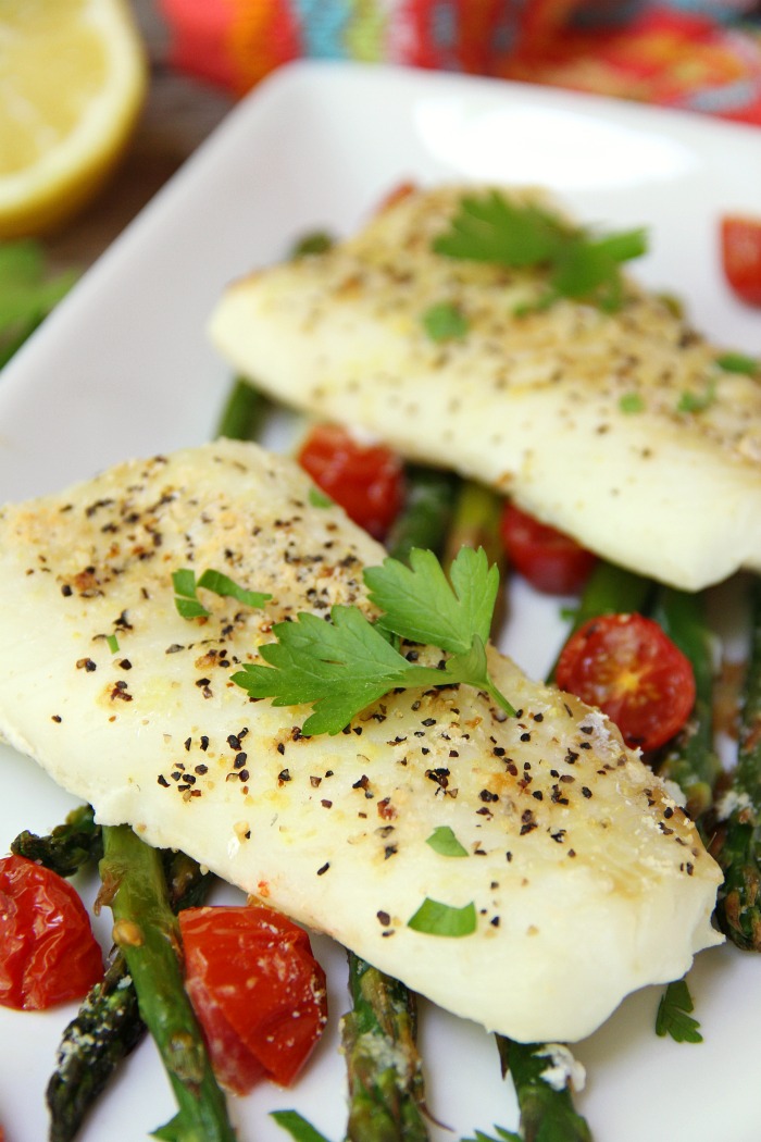 Sheet Pan Cod - A simple one-sheet recipe that features light, flaky cod alongside colorful asparagus and tomatoes. Lemon pepper, fresh lemon juice and grated Parmesan cheese top off the dish.