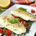 Sheet Pan Cod - A simple one-sheet recipe that features light, flaky cod alongside colorful asparagus and tomatoes. Lemon pepper, fresh lemon juice and grated Parmesan cheese top off the dish.