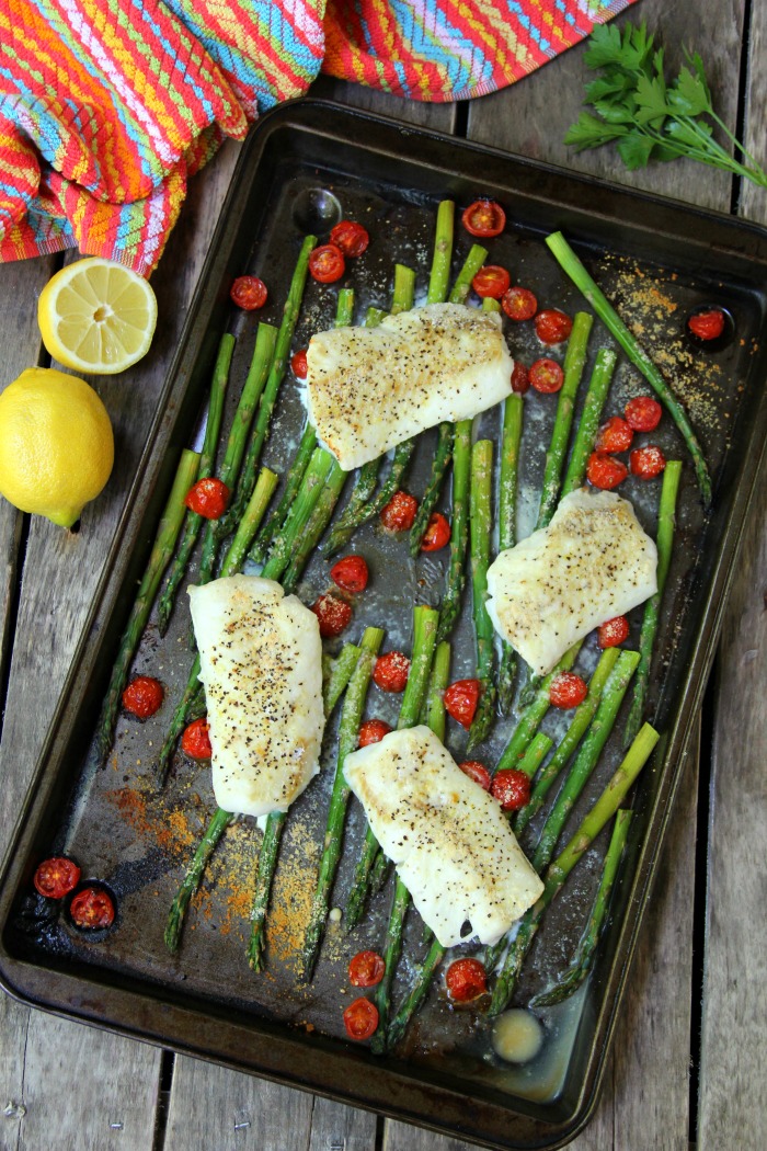 Sheet Pan Cod - A simple one-sheet recipe that features light, flaky cod alongside colorful asparagus and tomatoes. Lemon pepper, fresh lemon juice and grated Parmesan cheese top off the dish.