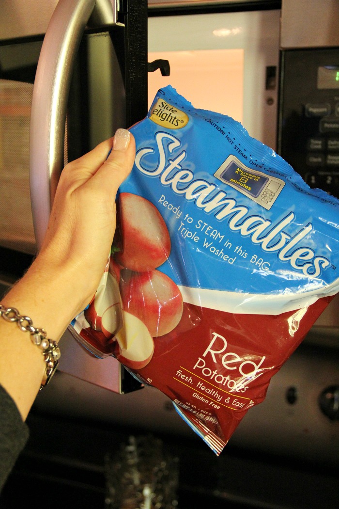 Twice Baked Potato Bowl - Baby reds are steamed, mashed, loaded with delicious toppings and then drizzled with a cheesy broccoli sauce. Tastes just like a twice baked potato but prepared in record time!