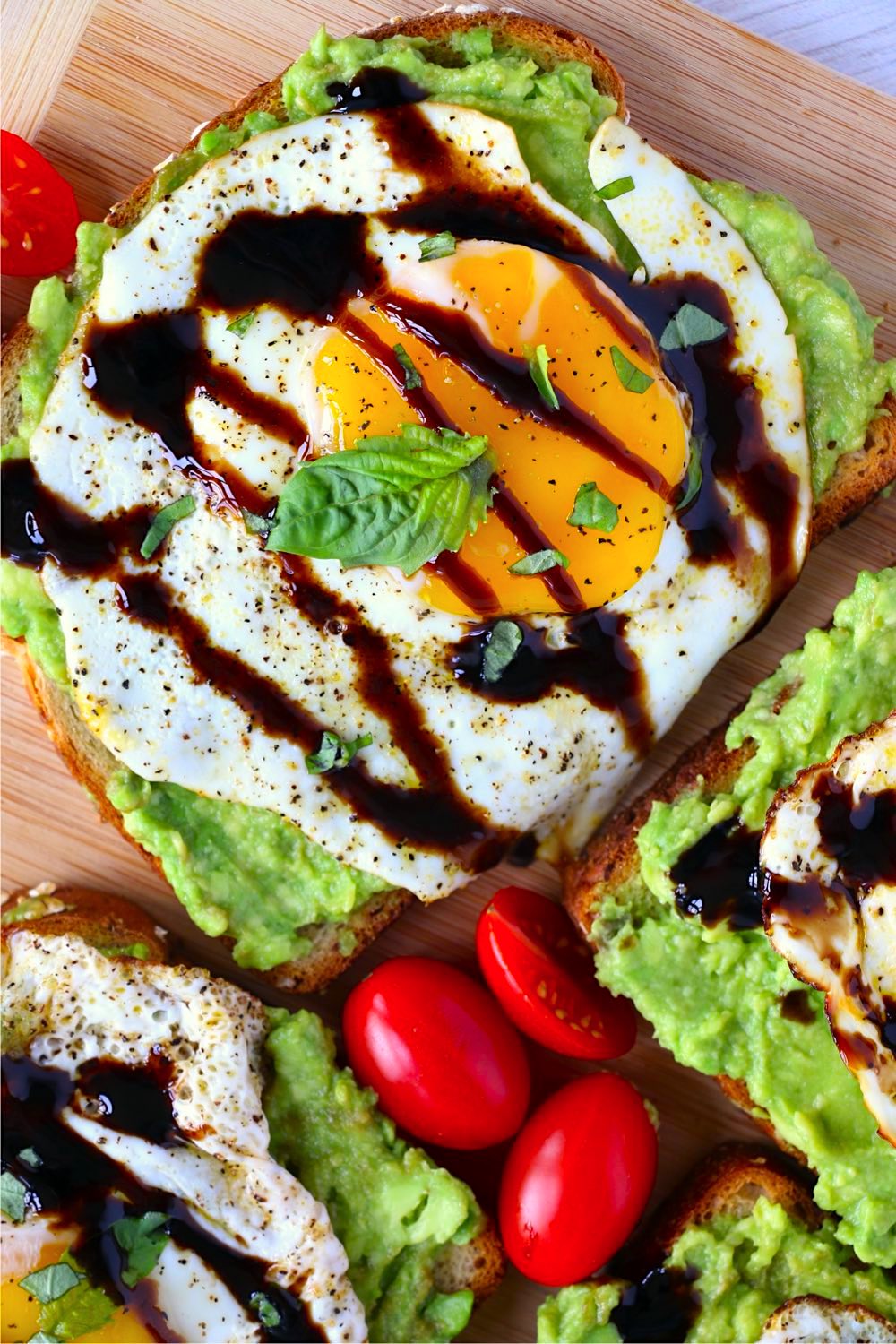 Sunny side up egg on avocado toast with balsamic glaze