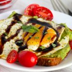 Egg on avocado toast with cherry tomatoes