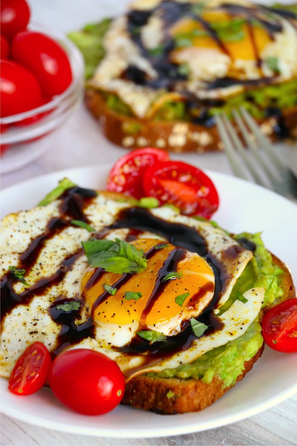 Egg with basil and balsamic glaze on avocado toast