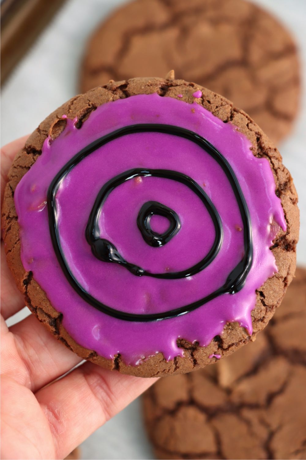 decorating a Halloween cookie