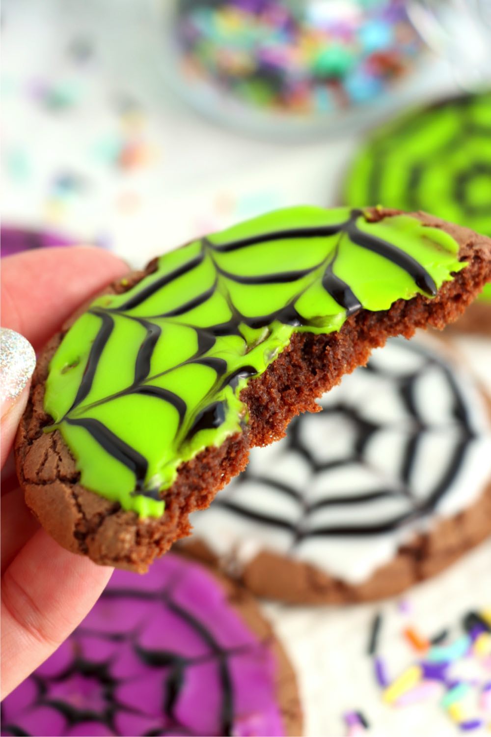 holding half of a Halloween cookie