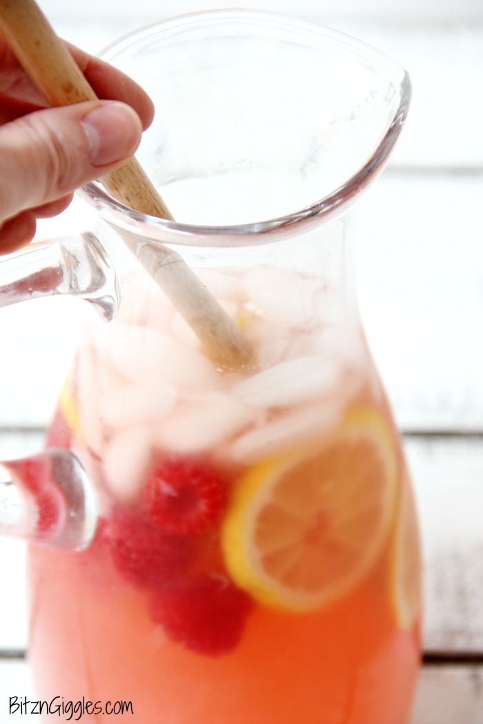 Pink Lemonade - Homemade pink lemonade made with fresh raspberries and lemons! So easy and so refreshing and delicious for a baby shower, summer party or picnic!