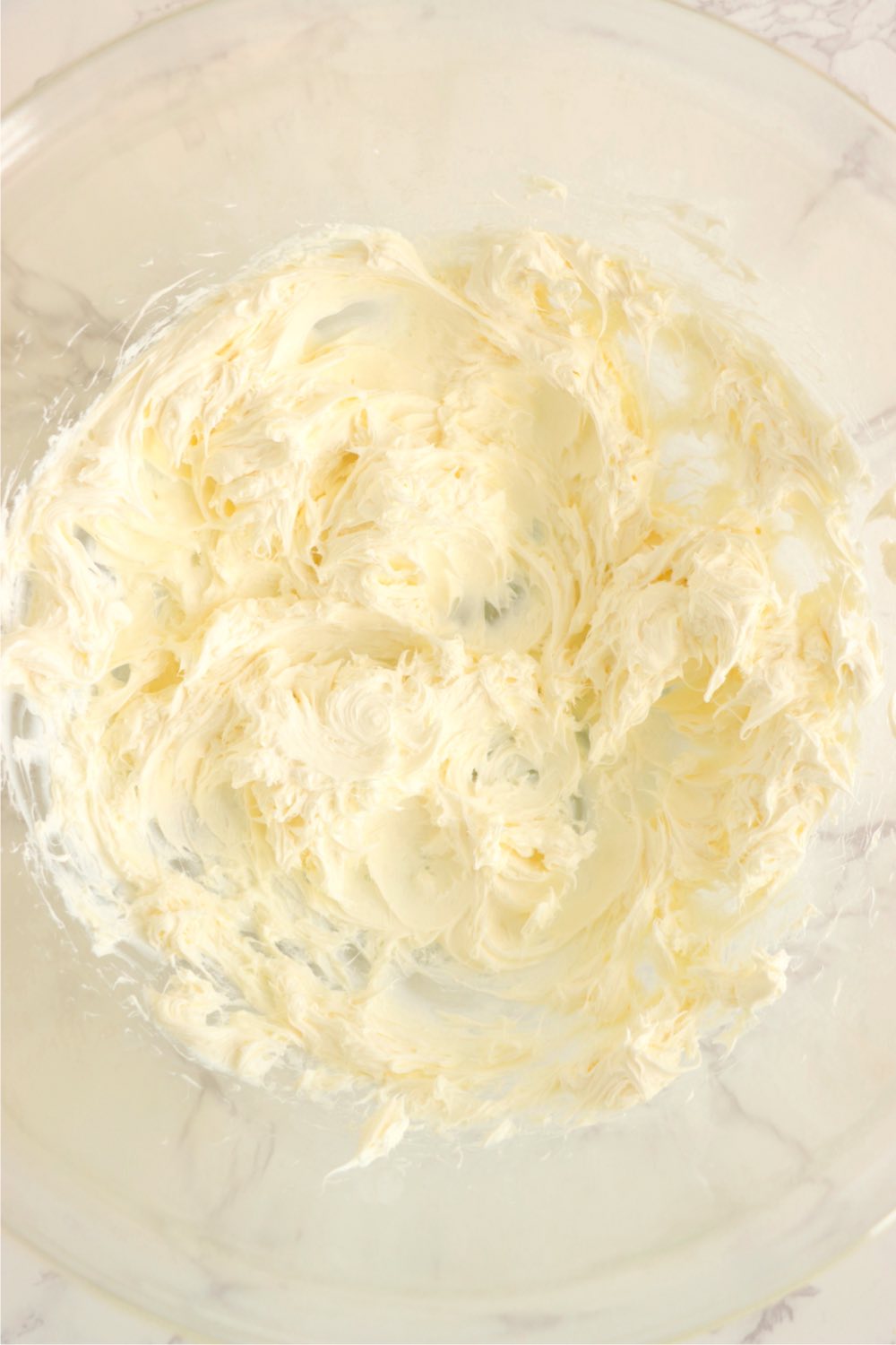 Whipped cream cheese in a mixing bowl.