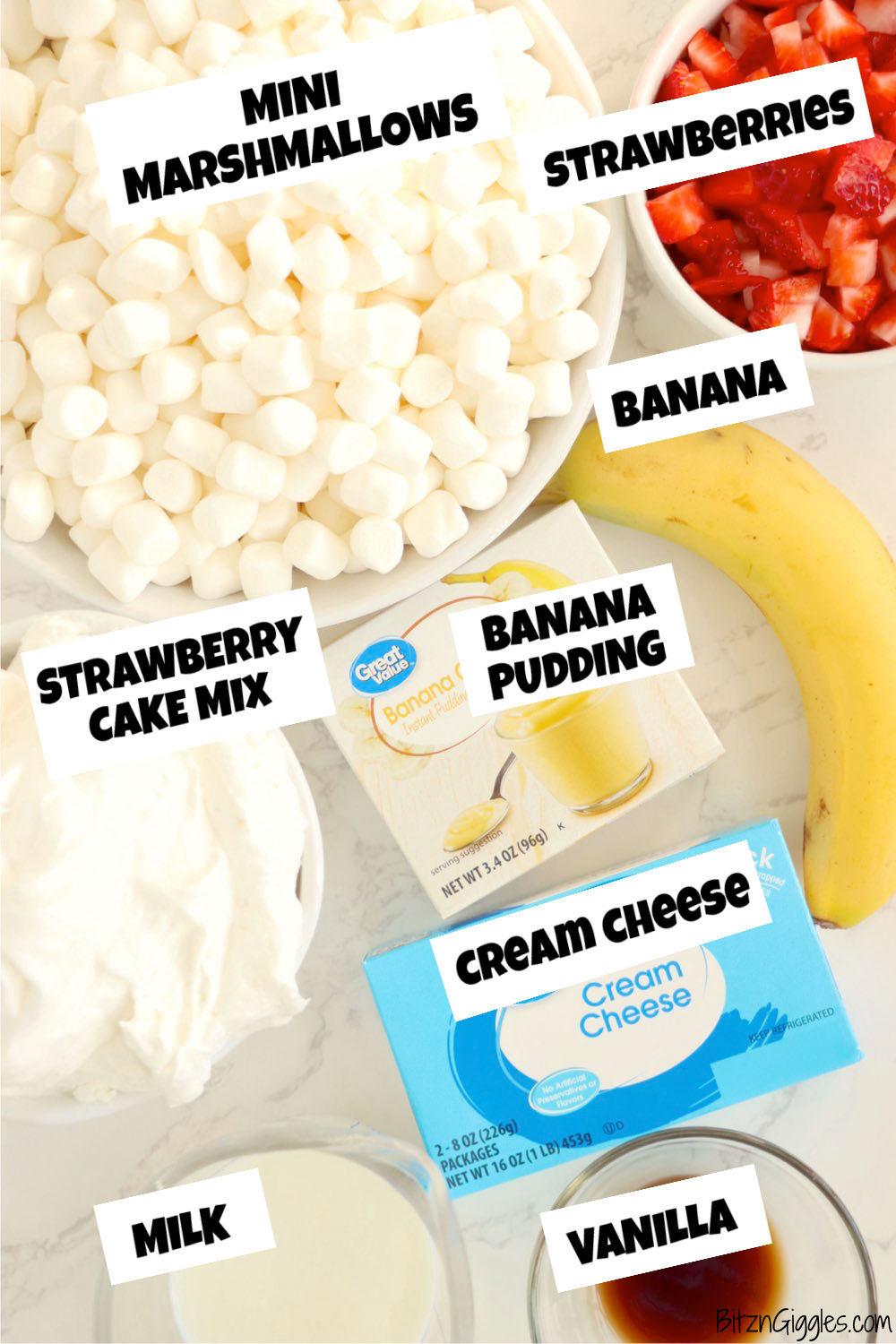ingredients for a strawberry and banana fluff salad laid out on a white table.