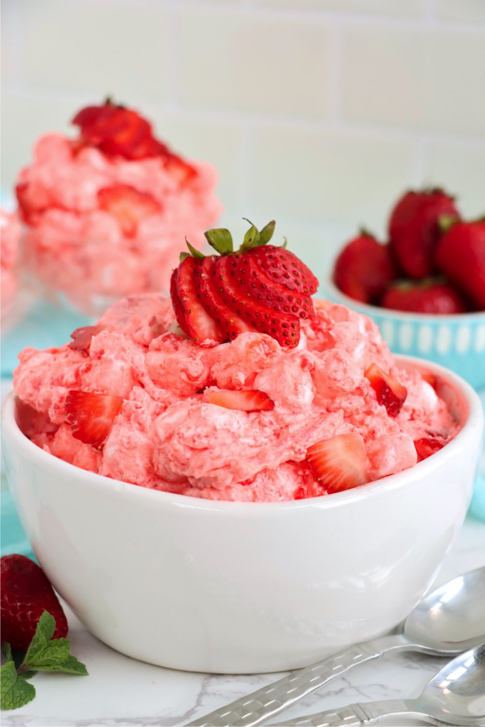 bowl of strawberry salad with fresh strawberries on top