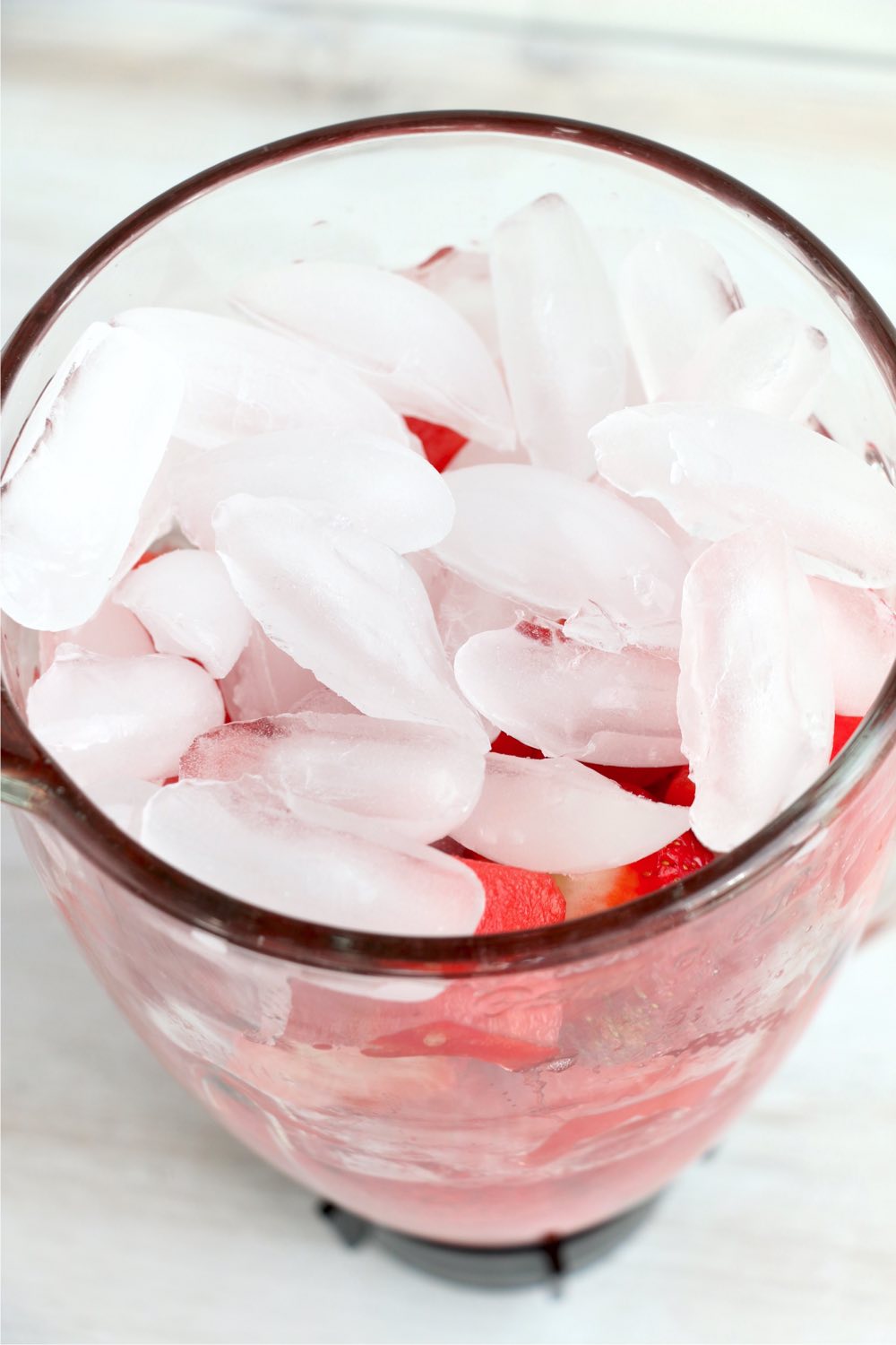 ice cubes on top of strawberries and watermelon