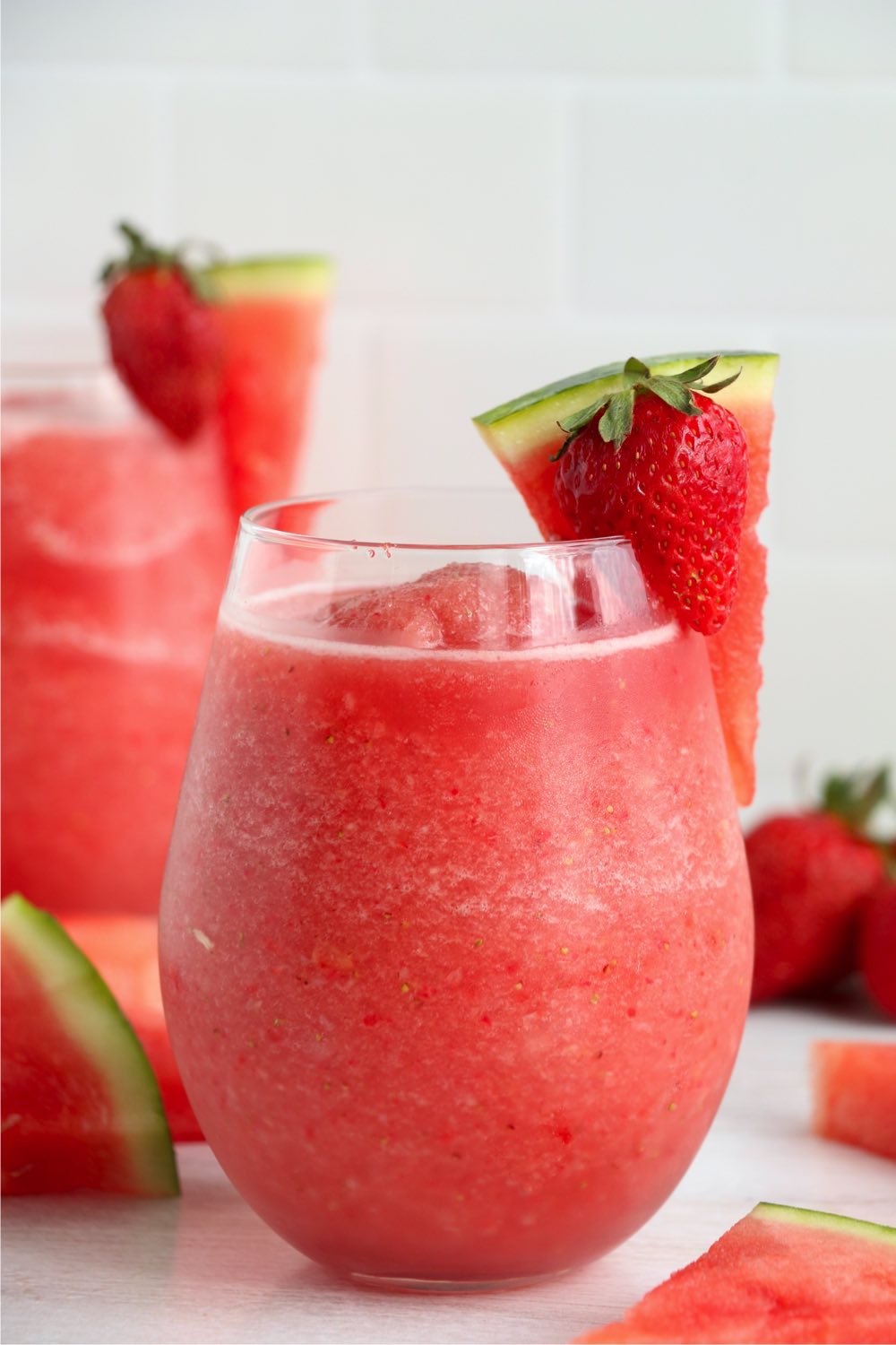 glass of slushie red wine with fruit garnish