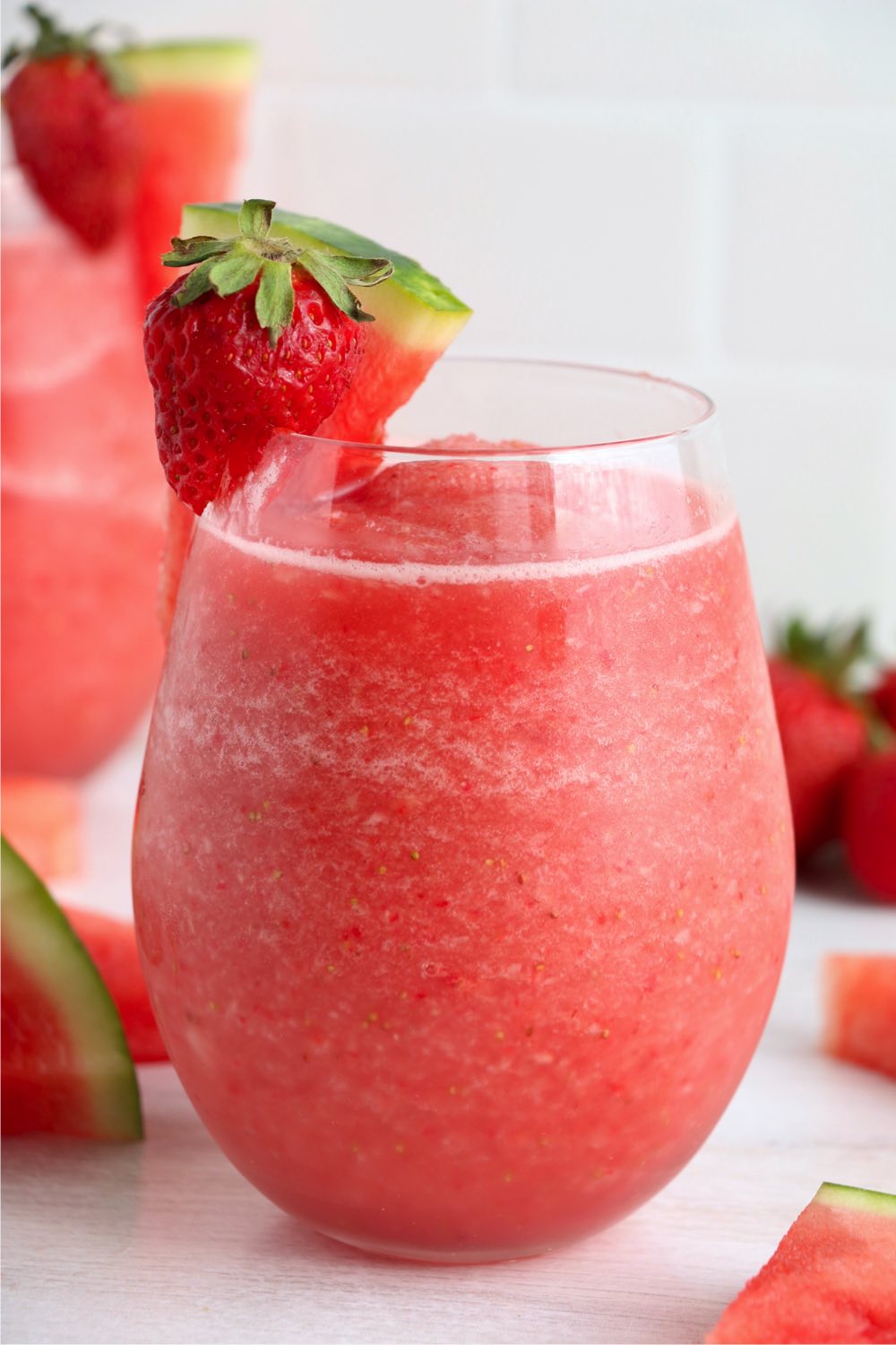 up close shot of frose wine with fruit garnish