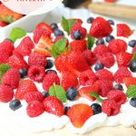 Triple Berry Pavlova - This meringue cake is crisp on the outside and soft and light on the inside! Topped with homemade whipped cream and fresh berries, it's such an elegant, light and delicious dessert!