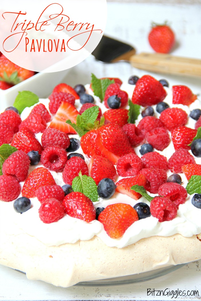 Triple Berry Pavlova - This meringue cake is crisp on the outside and soft and light on the inside! Topped with homemade whipped cream and fresh berries, it's such an elegant, light and delicious dessert!