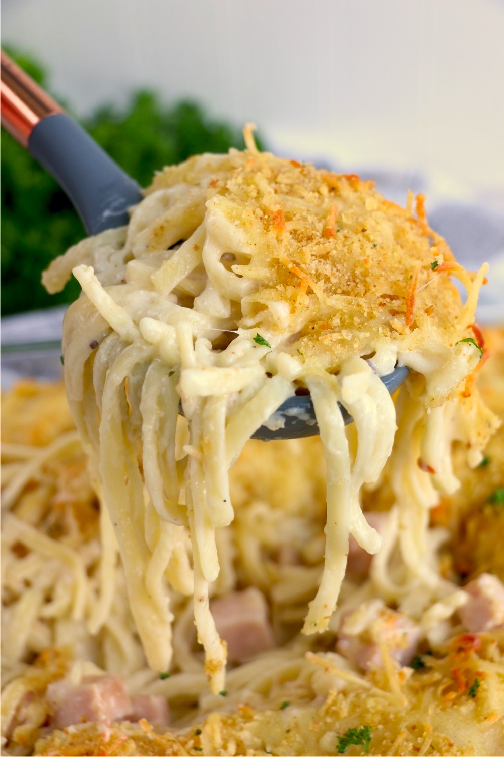 spoonful of turkey tetrazzini held over casserole dish
