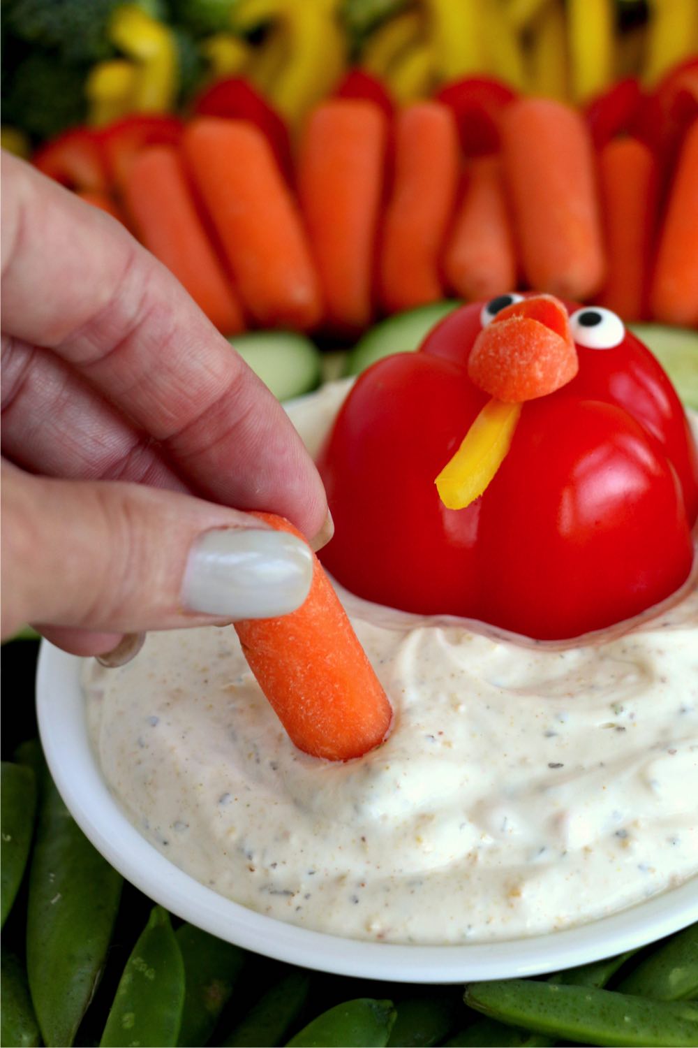dipping a carrot into veggie dip