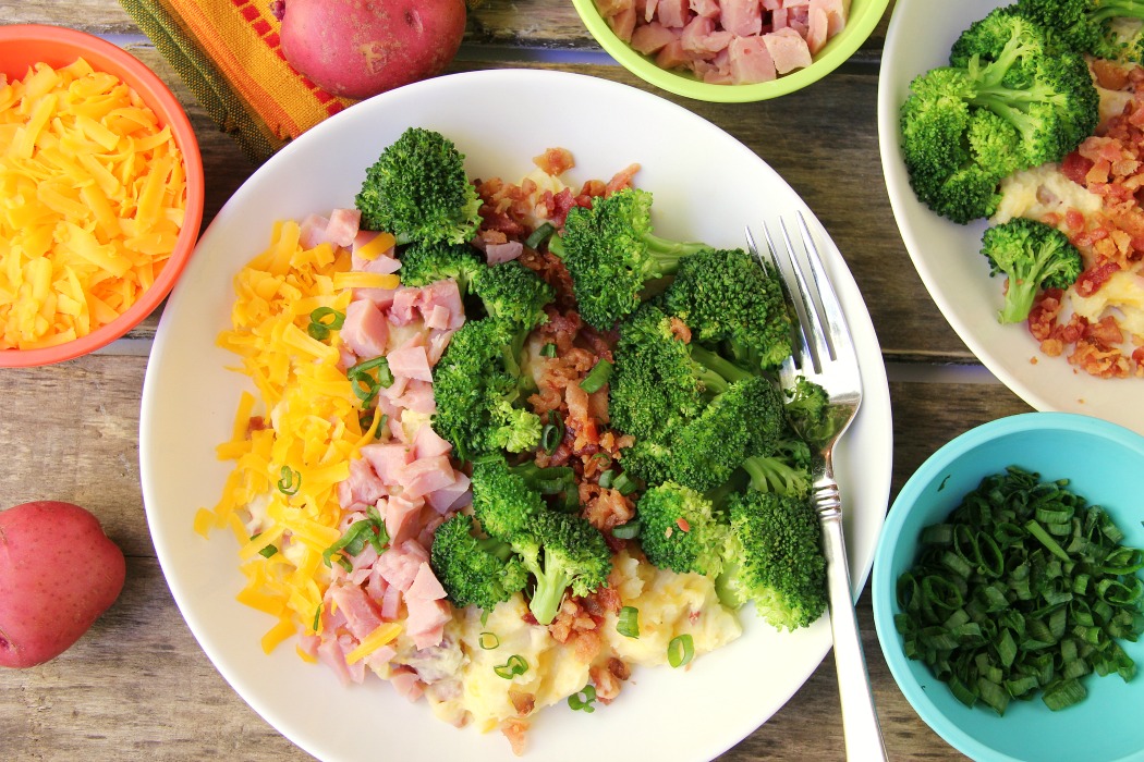 Twice Baked Potato Bowl - Baby reds are steamed, mashed, loaded with delicious toppings and then drizzled with a cheesy broccoli sauce. Tastes just like a twice baked potato but prepared in record time!