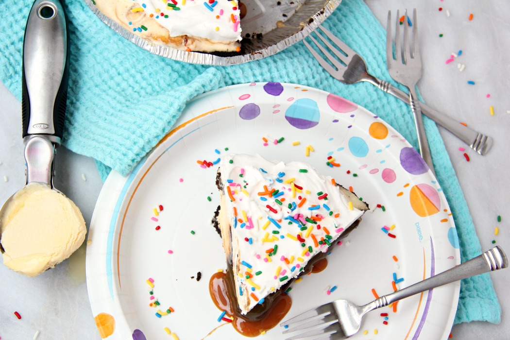 Ultimate Ice Cream Sundae Pie - Fudge and caramel topping filled ice cream pie with a fluffy whipped topping covered in sprinkles!