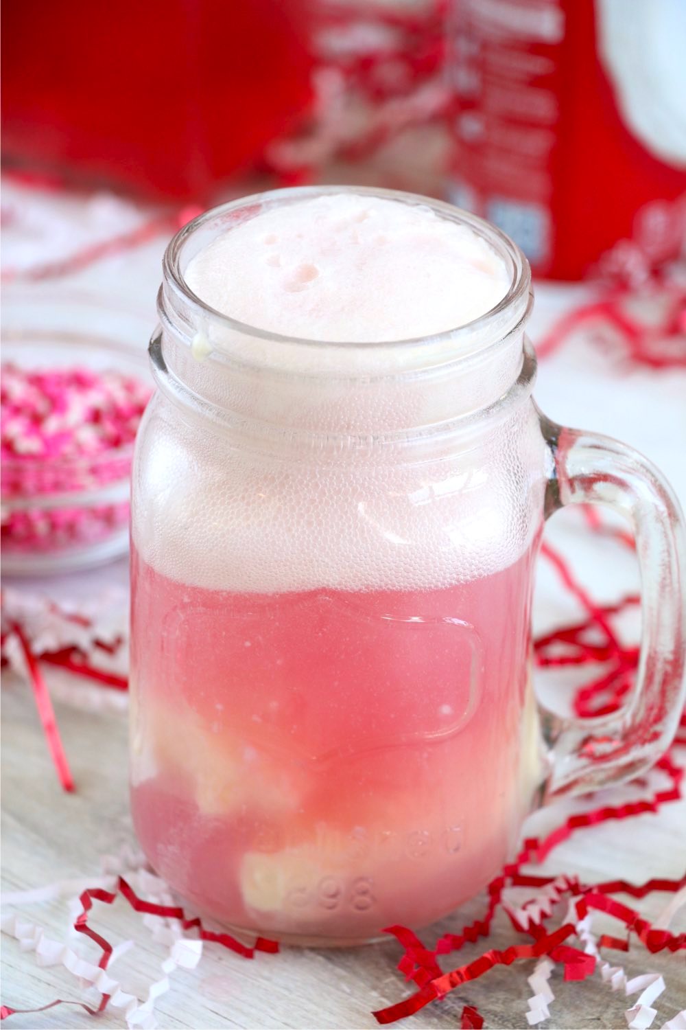 whipped topping in glass with cherry soda and ice cream