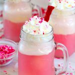 cherry float topped with whipped cream, sprinkles and a licorice straw