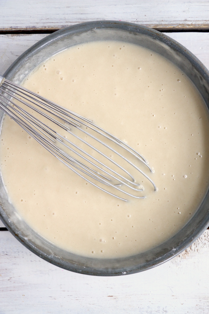 whisking cake batter together in pan
