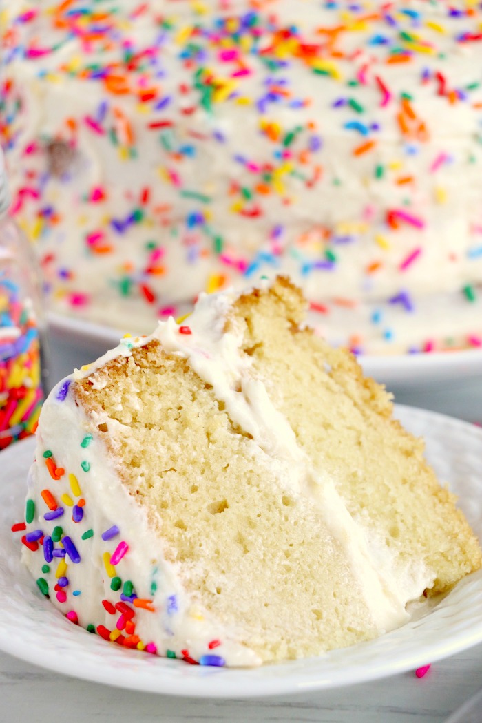 piece of layer cake with frosting and sprinkles