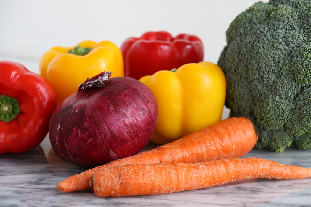 Halloween Veggie Pizza - A spooky themed graveyard pizza featuring a flavorful ranch cream cheese covered crust, topped with colorful veggies and "tombstone" crackers.