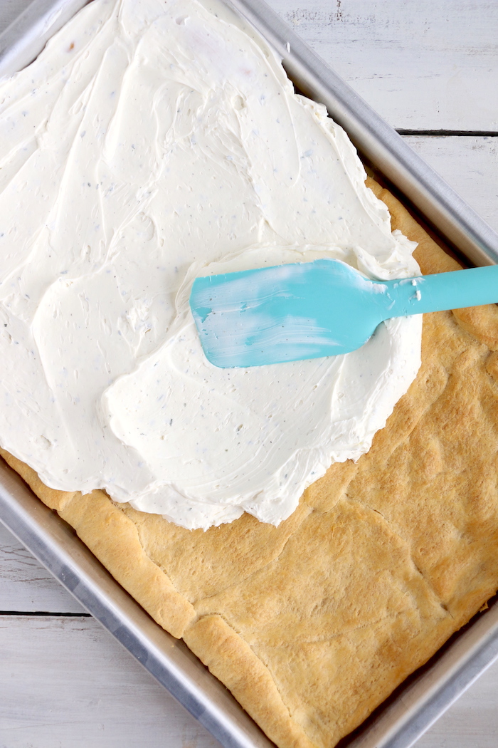 Halloween Veggie Pizza - A spooky themed graveyard pizza featuring a flavorful ranch cream cheese covered crust, topped with colorful veggies and "tombstone" crackers.