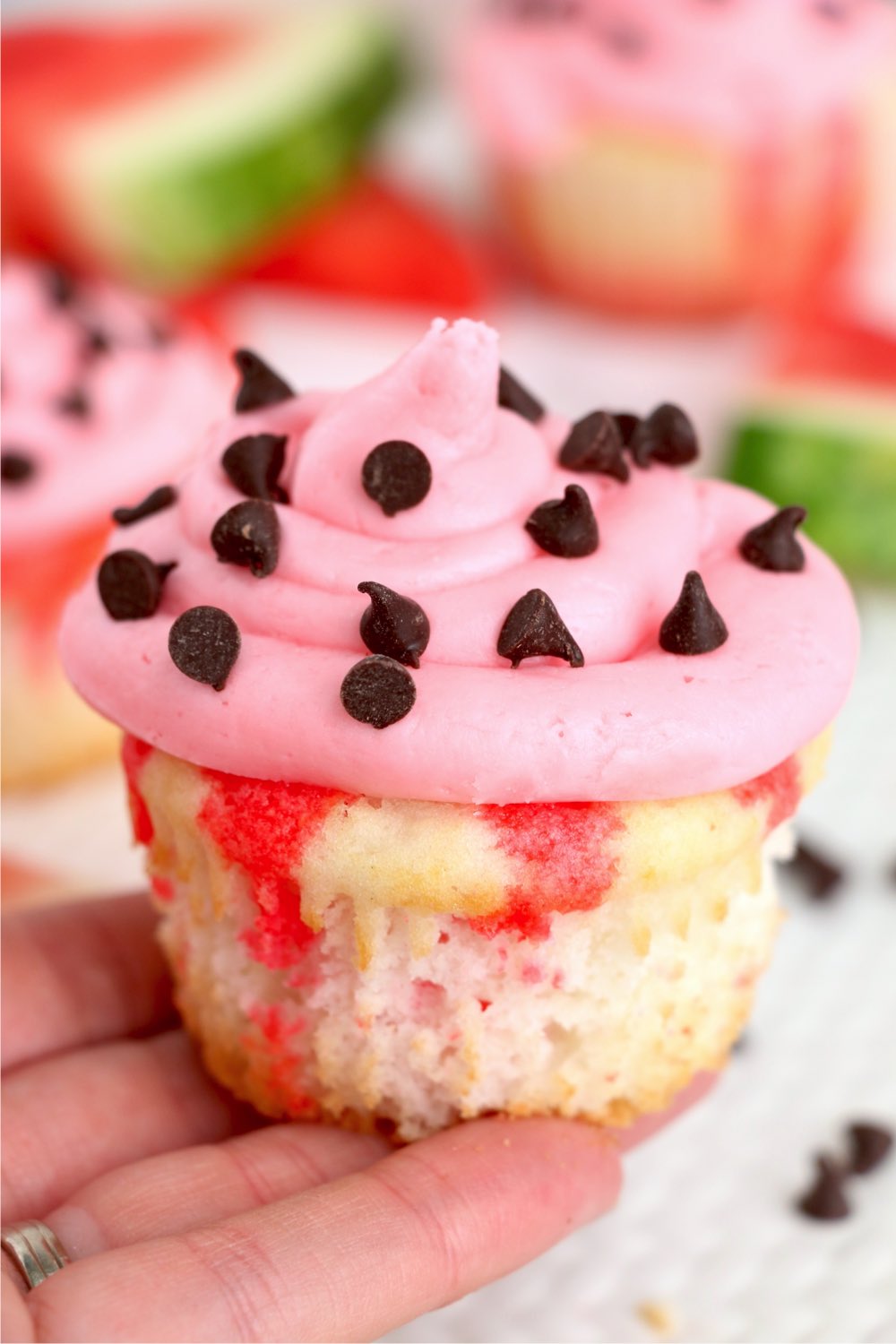 hand holding a watermelon cupcake