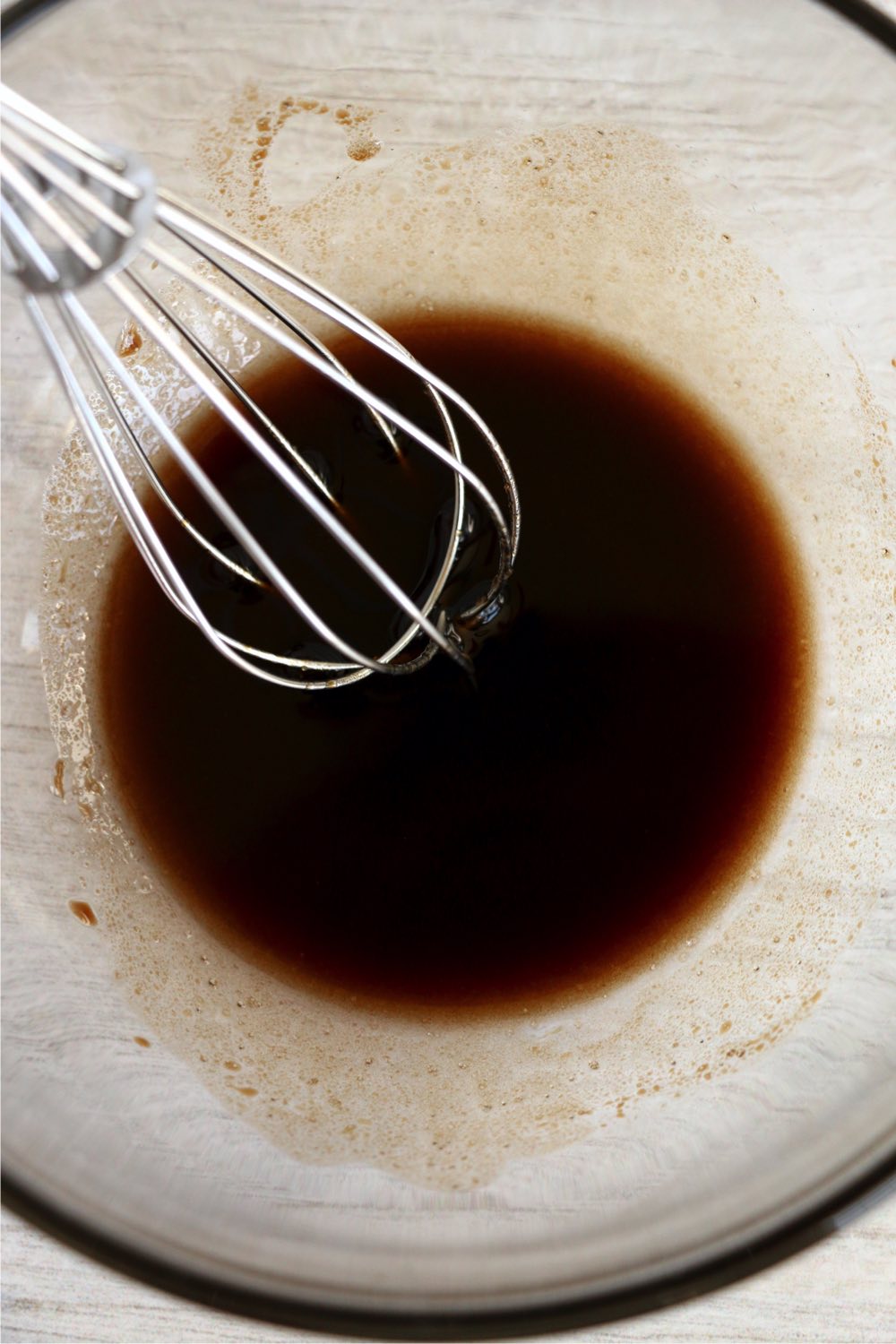 whisking together balsamic vinegar, olive oil and salt