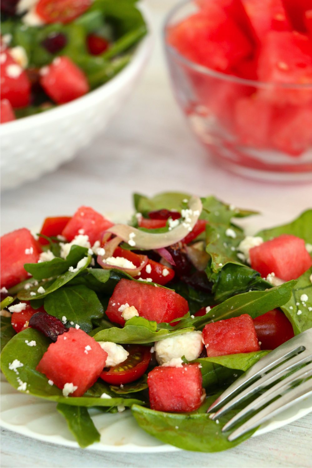 fork on plate of watermelon feta salad
