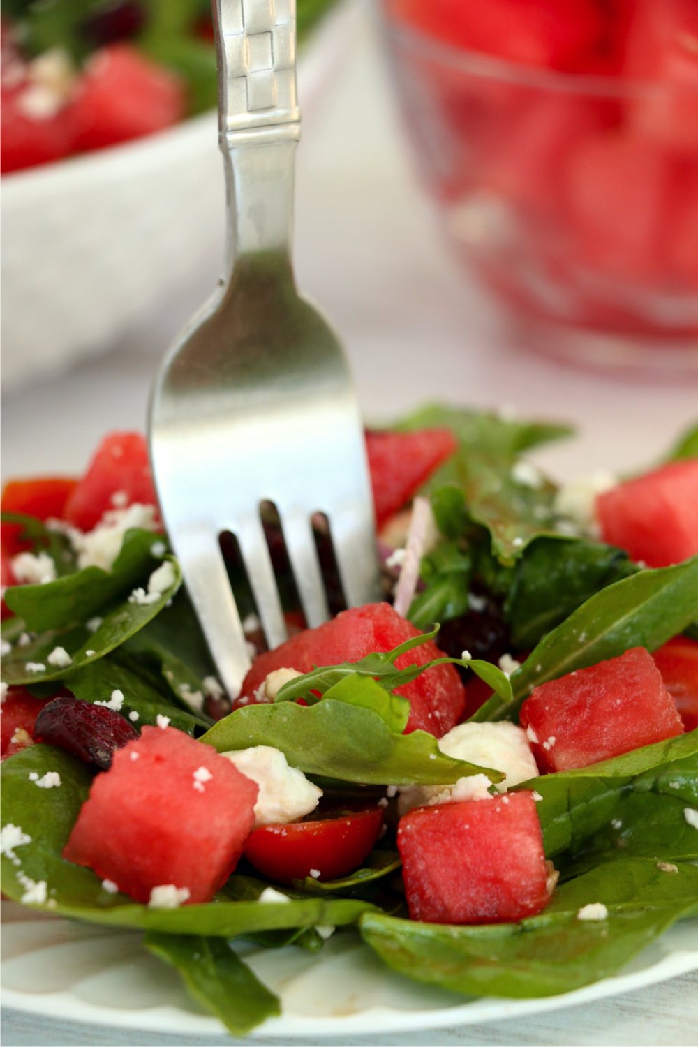 fork sinking into watermelon feta salad