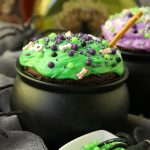 Witch Cauldron Mug Cake - A chocolate mug cake made in a ceramic witch cauldron with halloween-themed frosting and sprinkles!