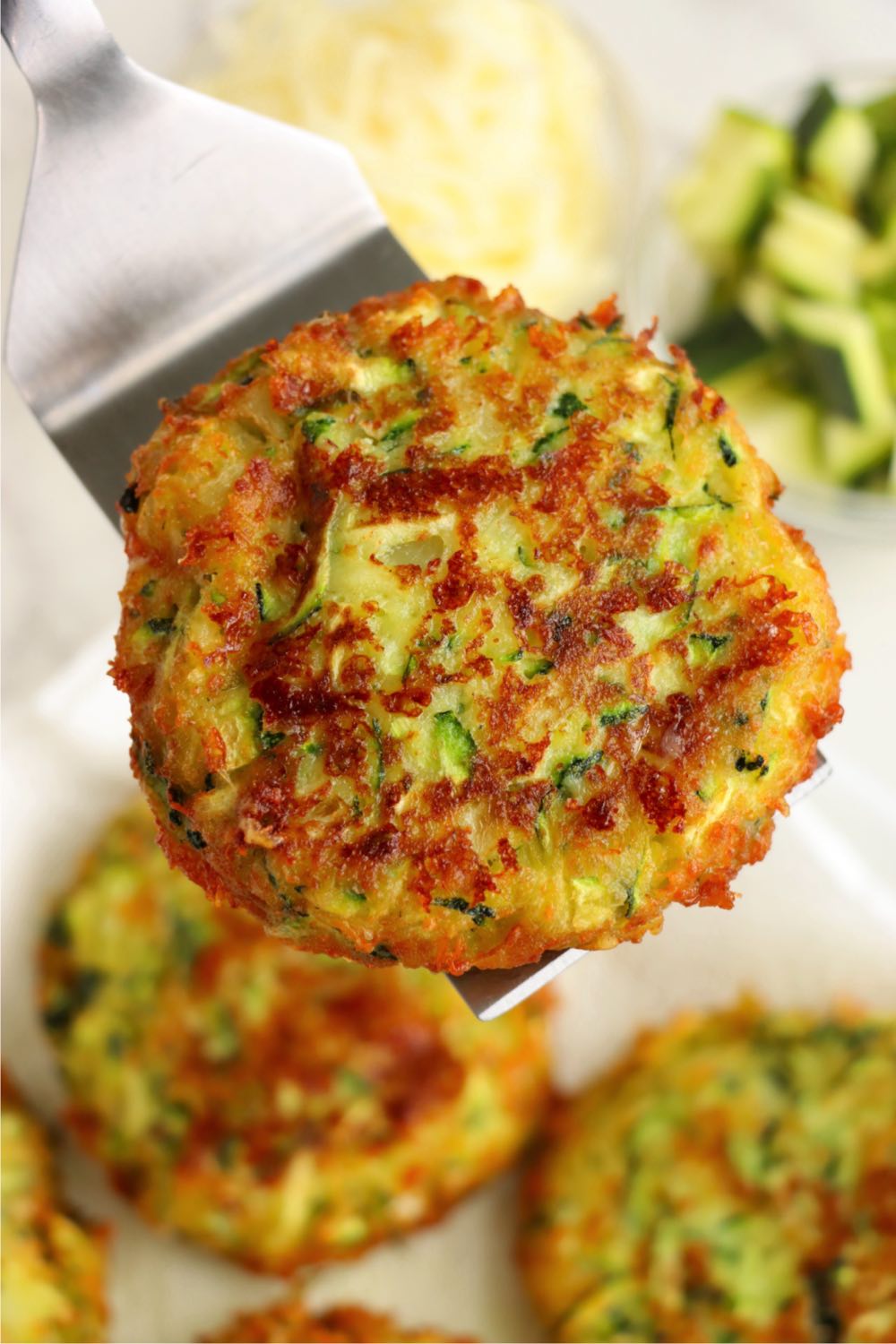 Zucchini patty on metal spatula