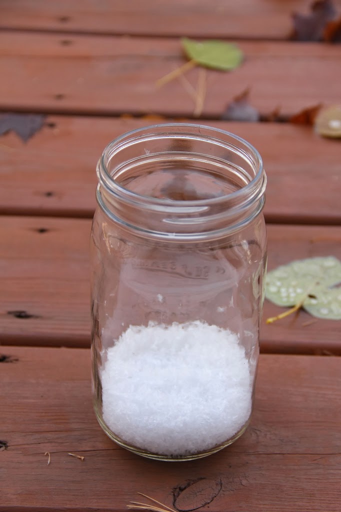 Illuminated Snow Scene in a Jar - An LED tea light illuminates a decorative winter scene inside of a mason jar. Such an easy and beautiful decoration for winter and Christmas!